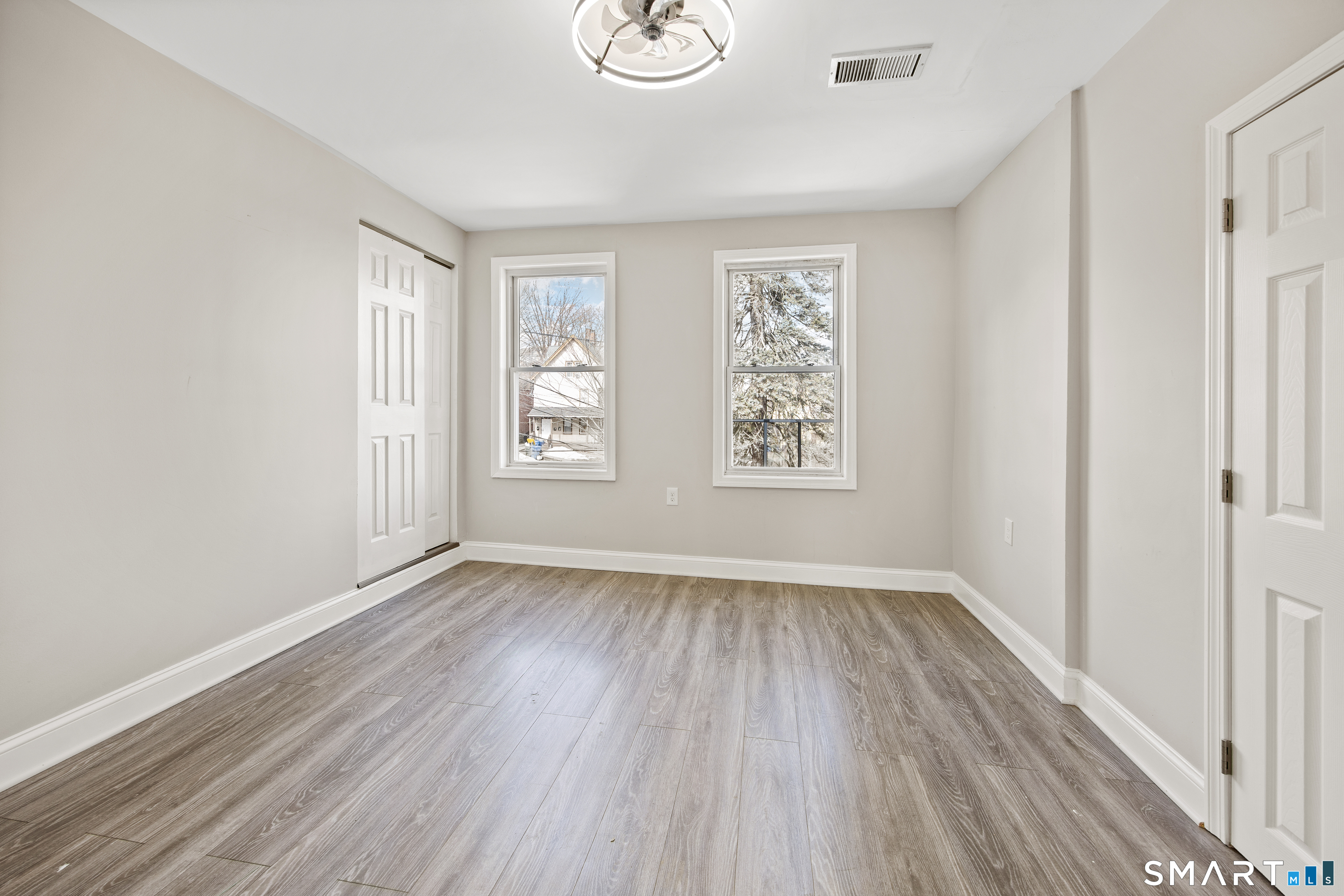 465 Washington Avenue Waterbury, CT 06708 - Photo 25 of 34 an empty room with wooden floor and windows