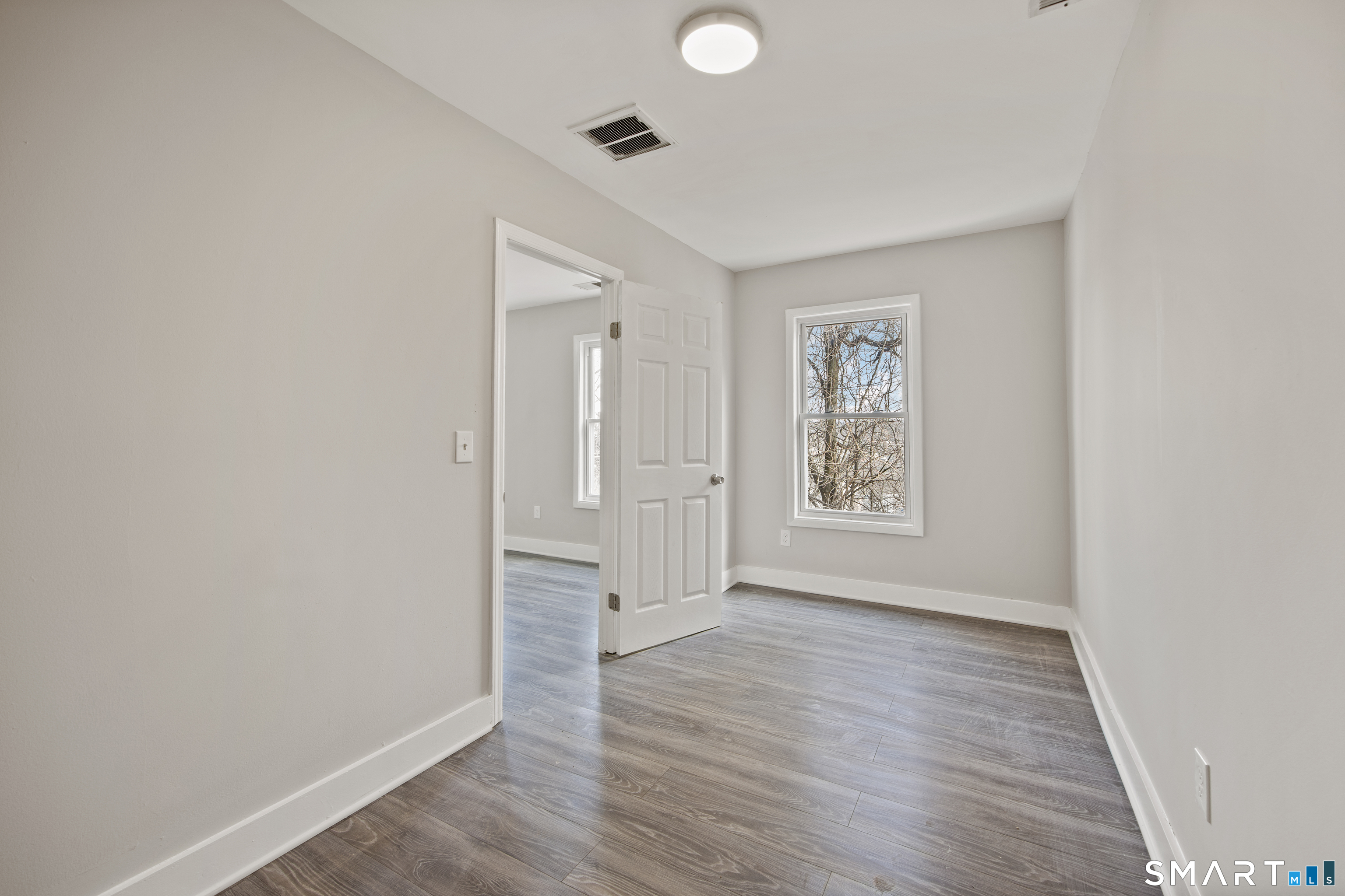 465 Washington Avenue Waterbury, CT 06708 - Photo 29 of 34 an empty room with wooden floor and windows