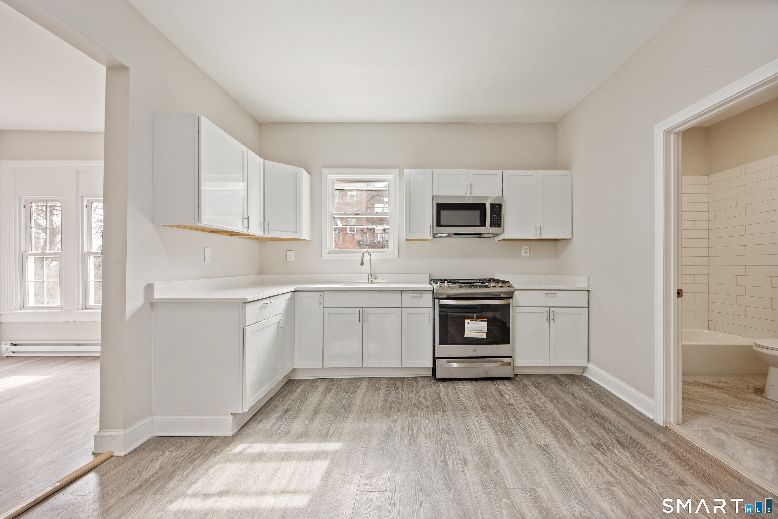 465 Washington Avenue Waterbury, CT 06708 - Photo 3 of 34 a kitchen with a refrigerator stove and a sink