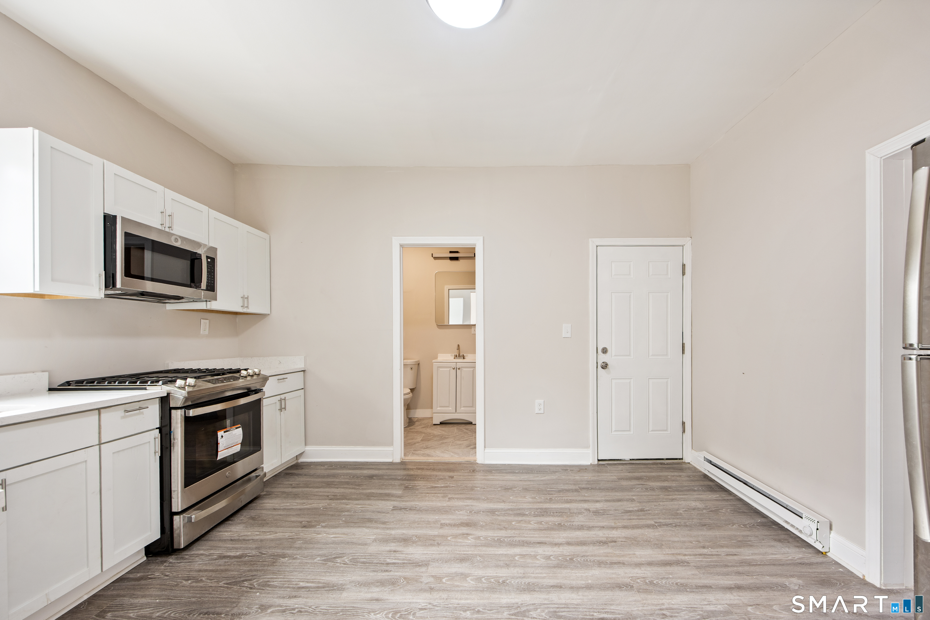 465 Washington Avenue Waterbury, CT 06708 - Photo 4 of 34 a view of a kitchen with a sink and a stove top oven