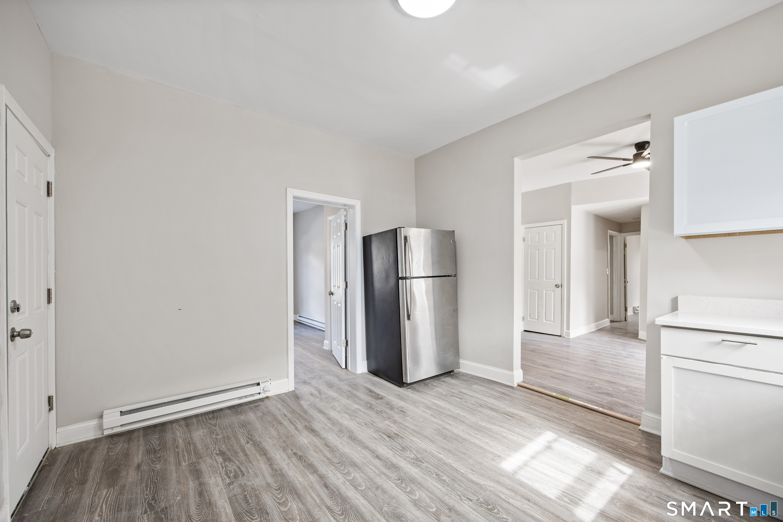 465 Washington Avenue Waterbury, CT 06708 - Photo 5 of 34 a view of a kitchen with refrigerator and wooden floor