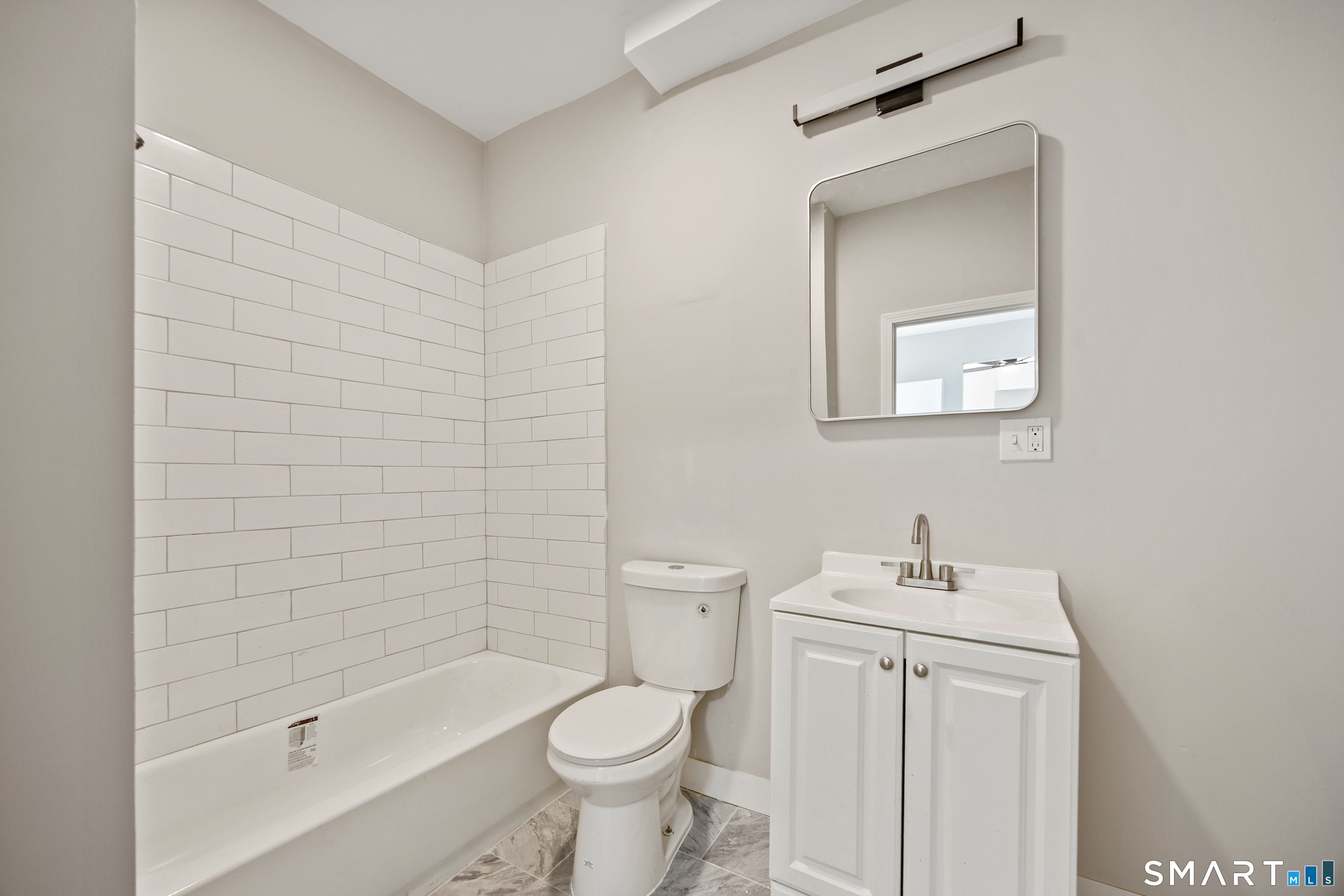 465 Washington Avenue Waterbury, CT 06708 - Photo 10 of 34 a bathroom with a bathtub shower sink vanity and toilet
