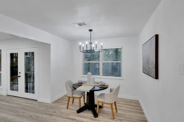 a workspace room with wooden floor and windows