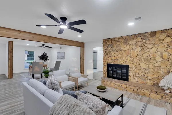 a living room with furniture and a fireplace