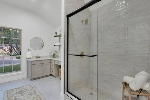 a bathroom with a granite countertop sink a toilet and shower