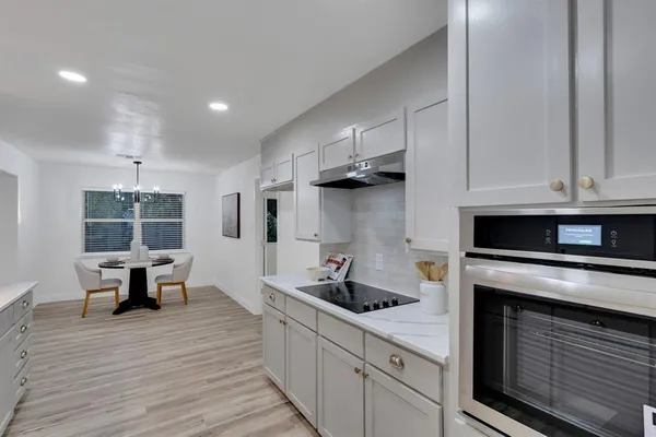 a kitchen with stainless steel appliances granite countertop a stove and a refrigerator