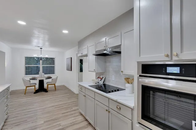 a kitchen with stainless steel appliances granite countertop a stove and a refrigerator