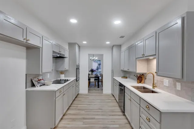 a kitchen with refrigerator and cabinets