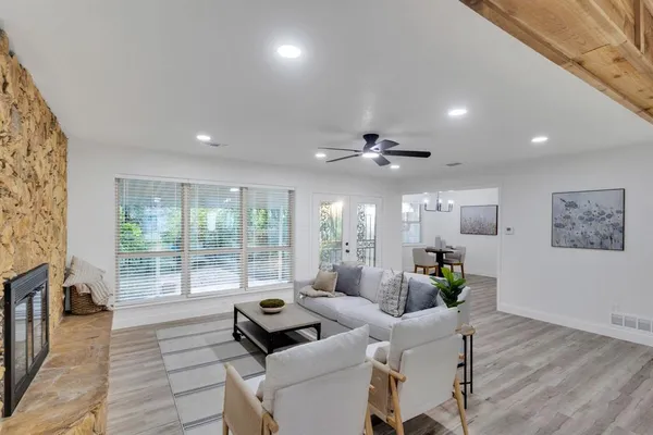 a living room with furniture and wooden floor