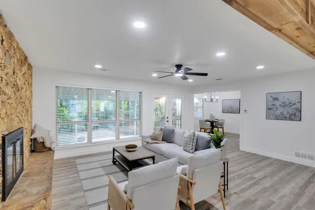 a living room with furniture and wooden floor