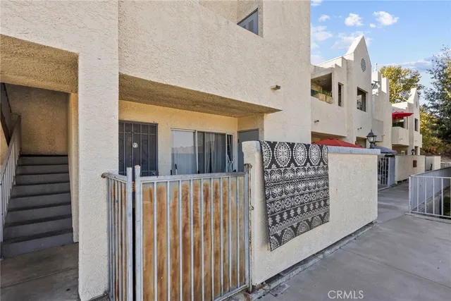 a view of a porch with a table and chairs