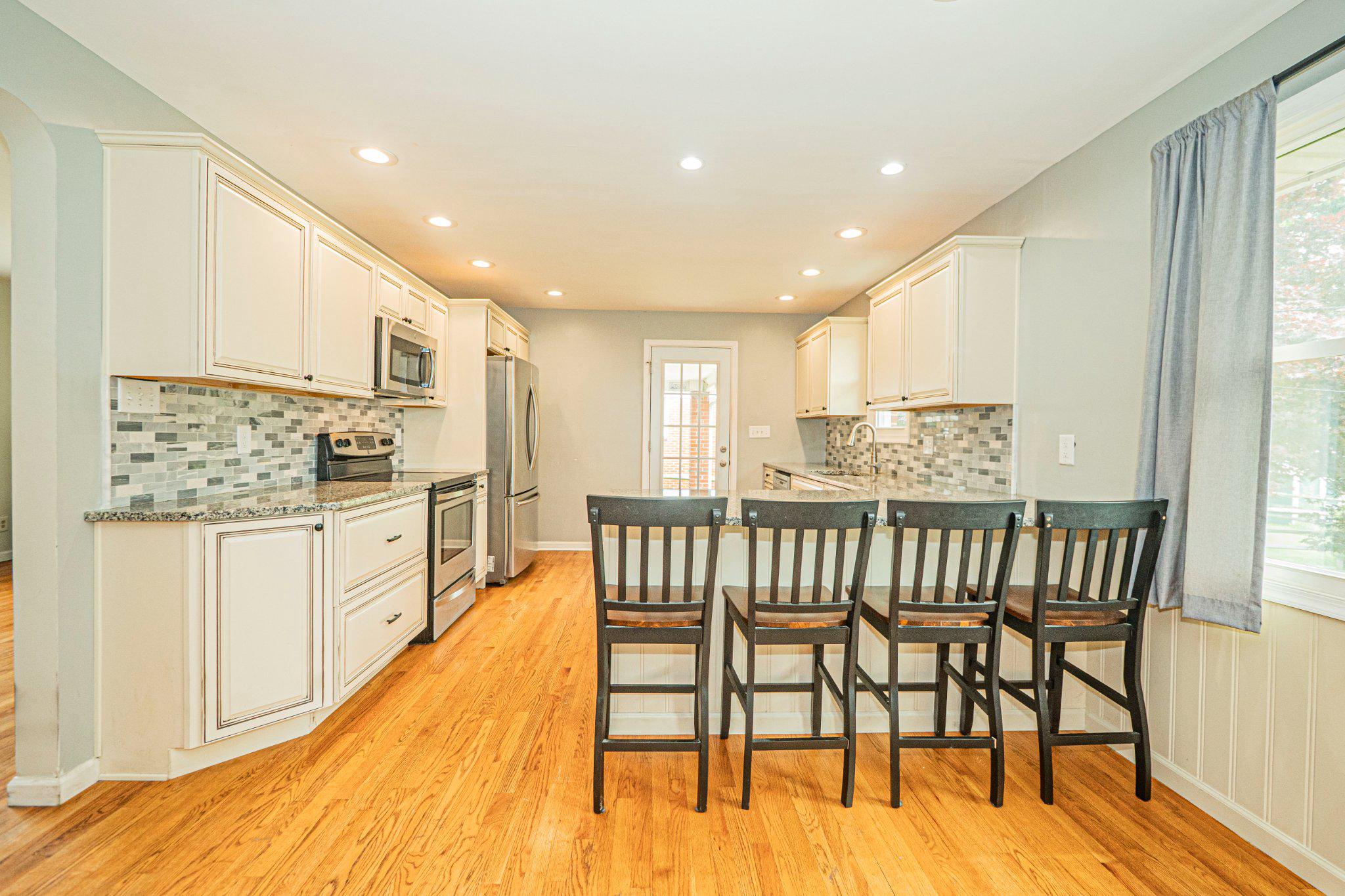 9907 Forge Park Road Perry Hall, MD 21128 - Photo 12 of 36 Modern kitchen with warm wood floors.