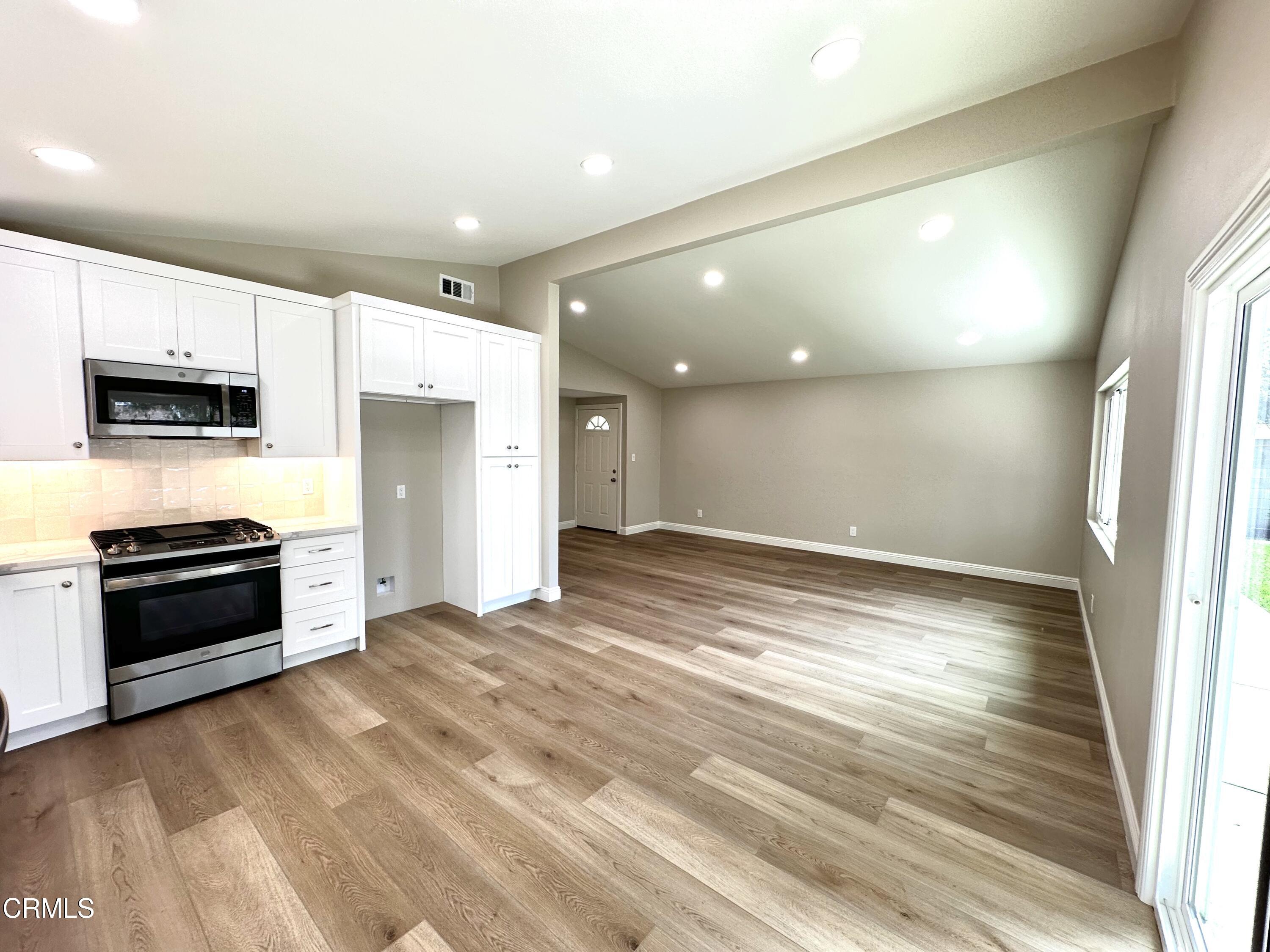 3031 Merced Place Oxnard, CA 93033 - Photo 11 of 26 a view of a kitchen with a sink and a stove top oven