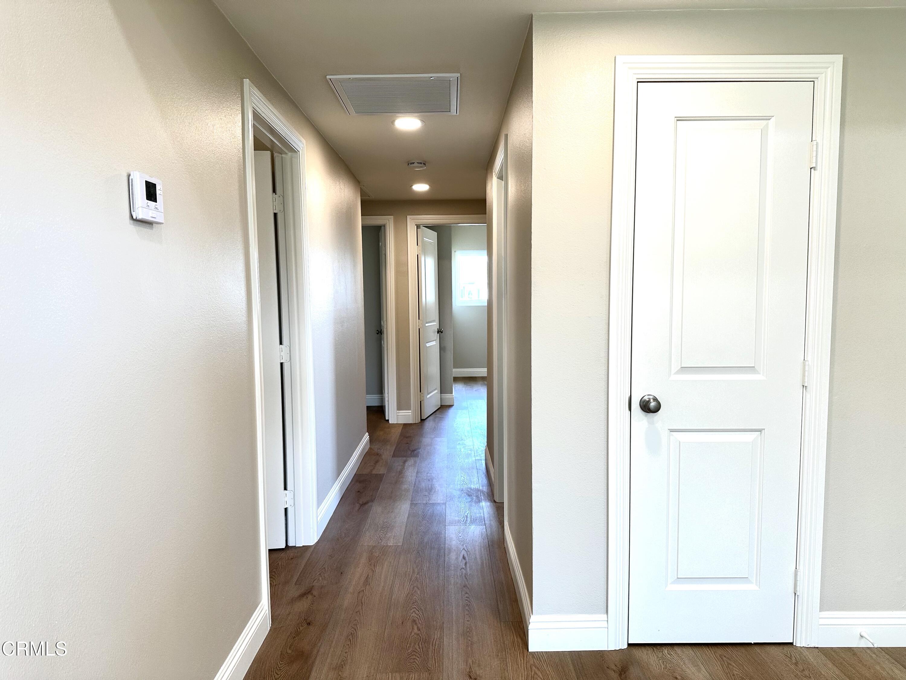 3031 Merced Place Oxnard, CA 93033 - Photo 12 of 26 a view of a hallway with wooden floor