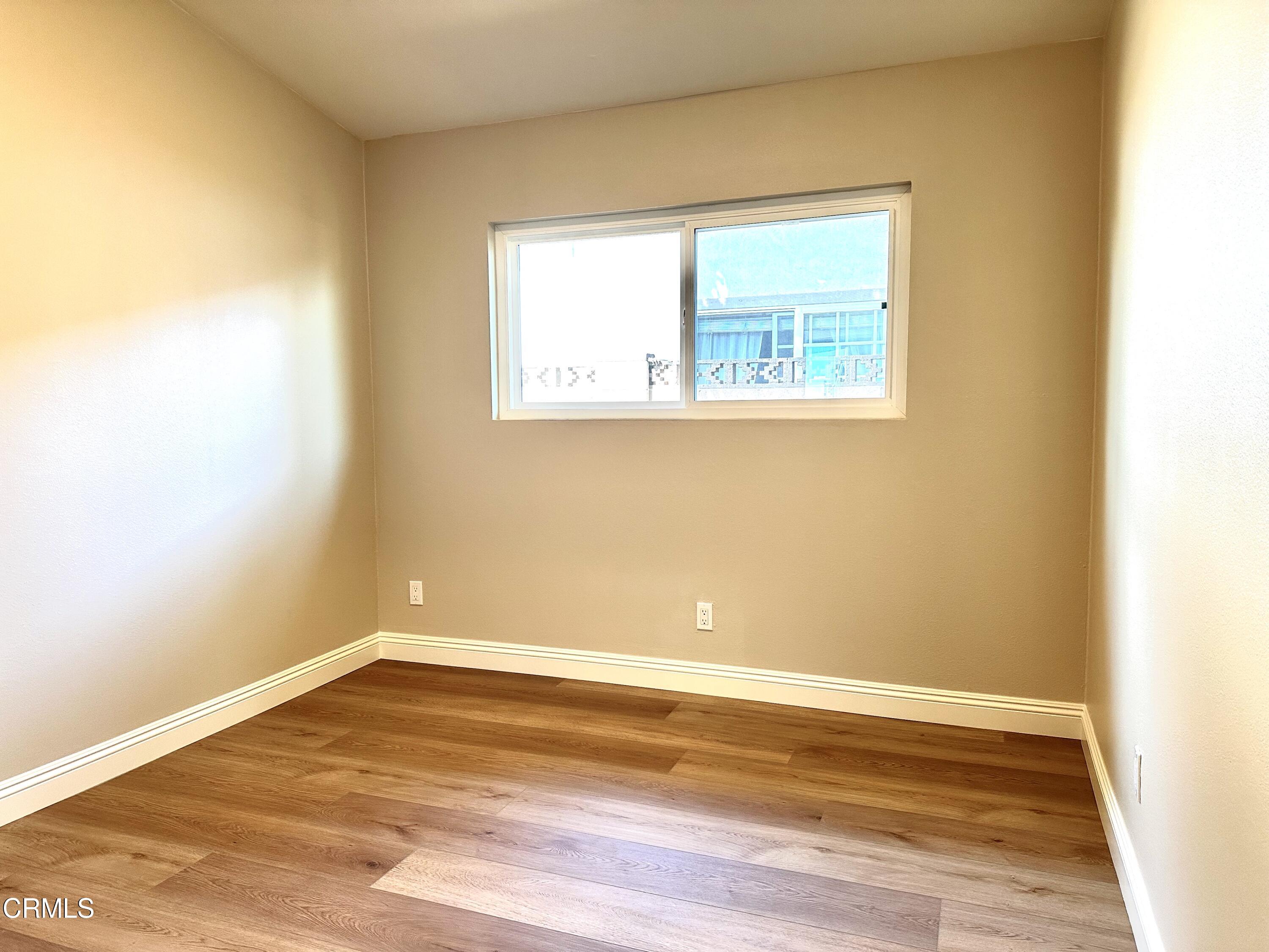 3031 Merced Place Oxnard, CA 93033 - Photo 13 of 26 a view of an empty room with wooden floor and a window