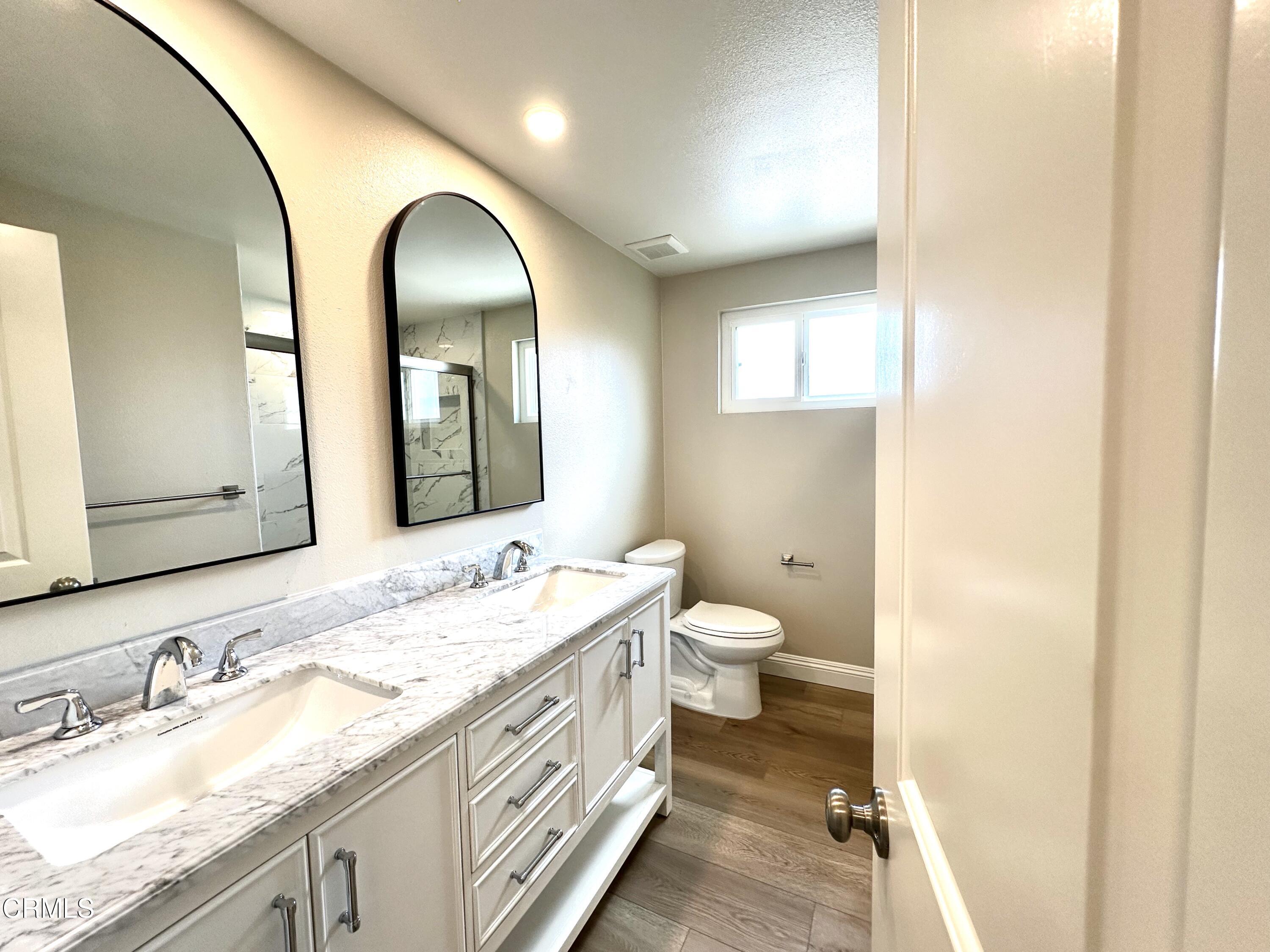 3031 Merced Place Oxnard, CA 93033 - Photo 14 of 26 a bathroom with a granite countertop double vanity sink and a mirror