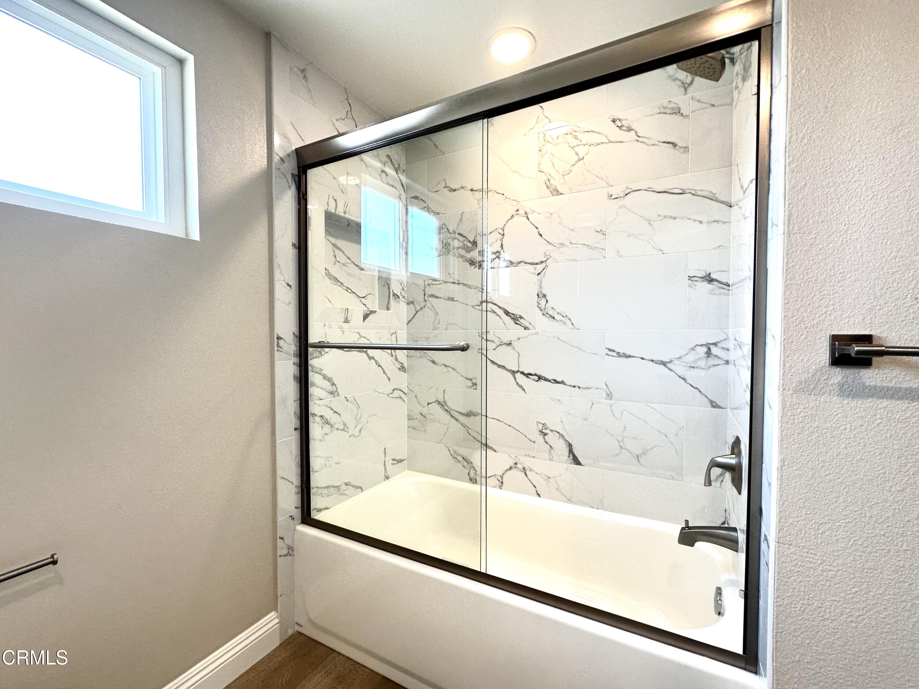 3031 Merced Place Oxnard, CA 93033 - Photo 15 of 26 a bathroom with a glass shower door