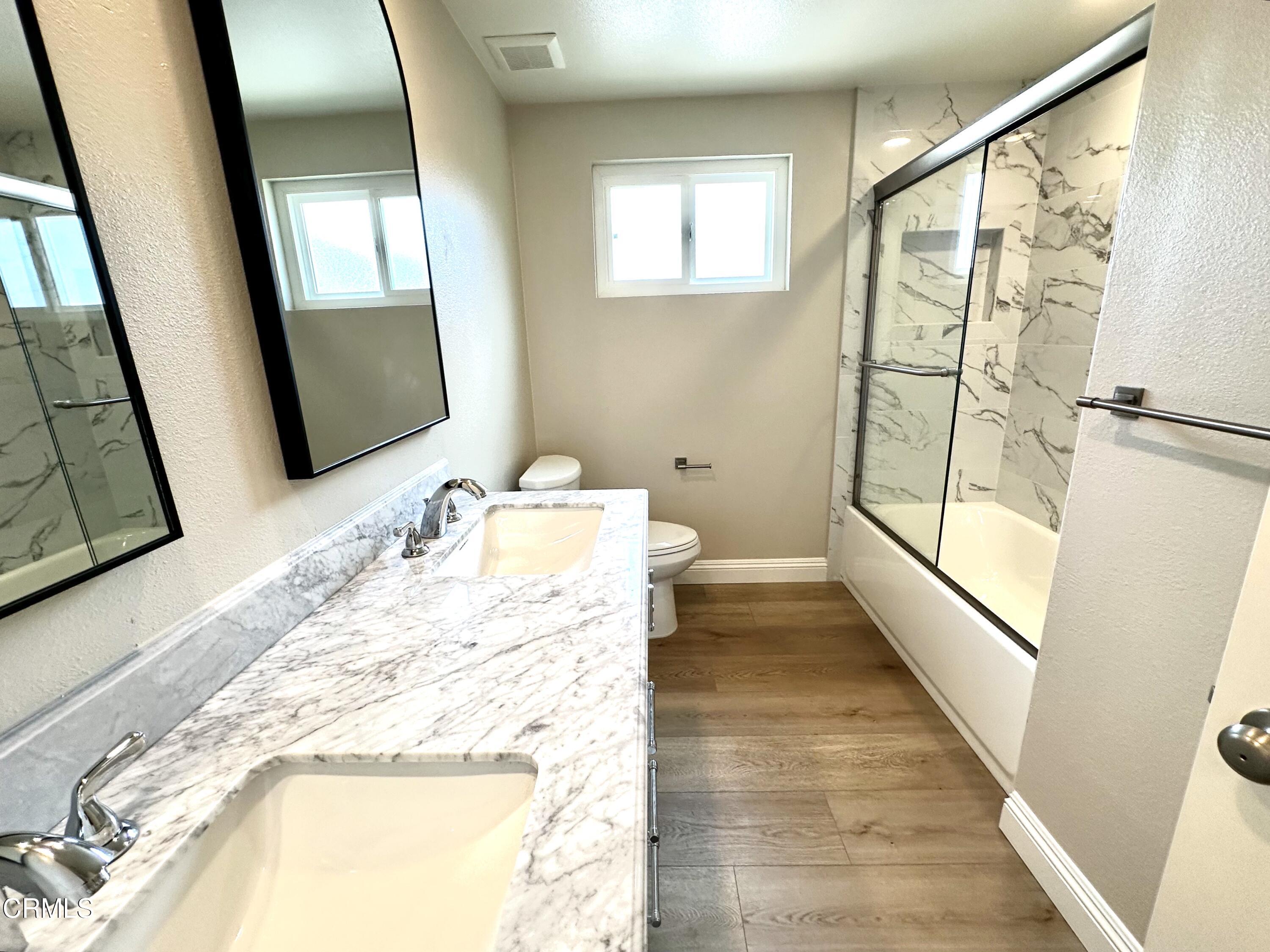 3031 Merced Place Oxnard, CA 93033 - Photo 16 of 26 a bathroom with a tub sink and mirror