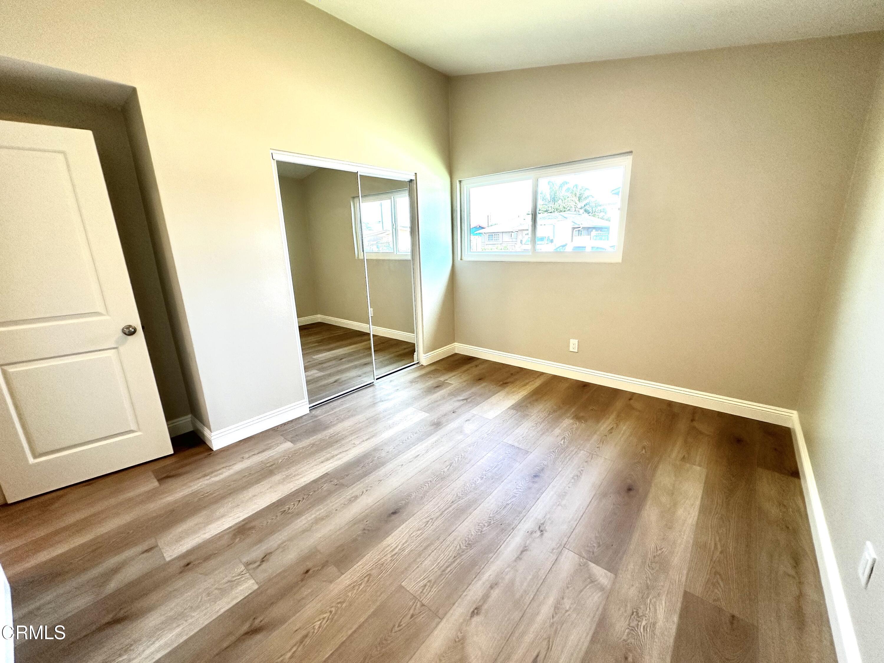 3031 Merced Place Oxnard, CA 93033 - Photo 18 of 26 a view of an empty room with wooden floor and a window