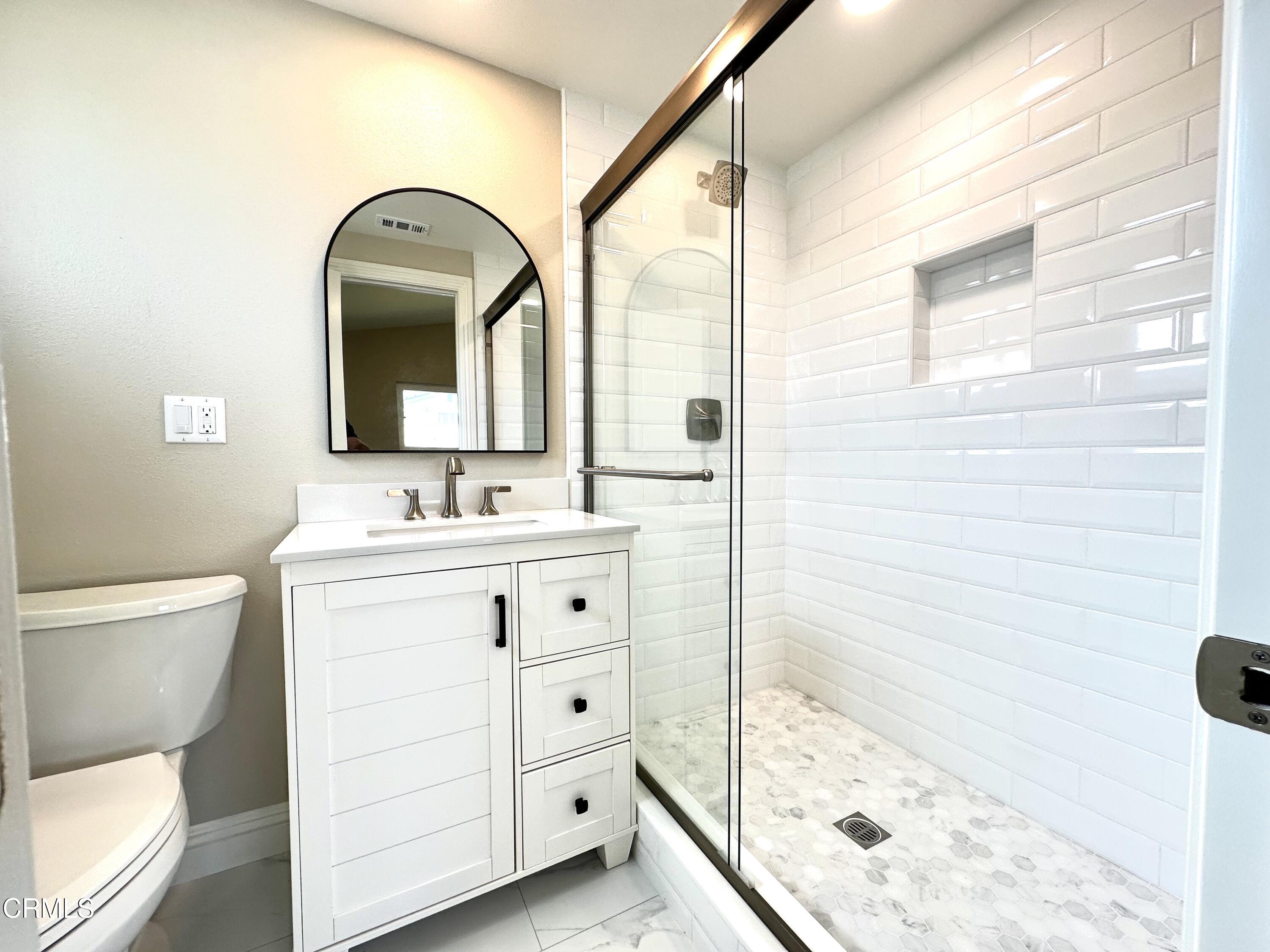 3031 Merced Place Oxnard, CA 93033 - Photo 19 of 26 a bathroom with a sink mirror and a bathtub