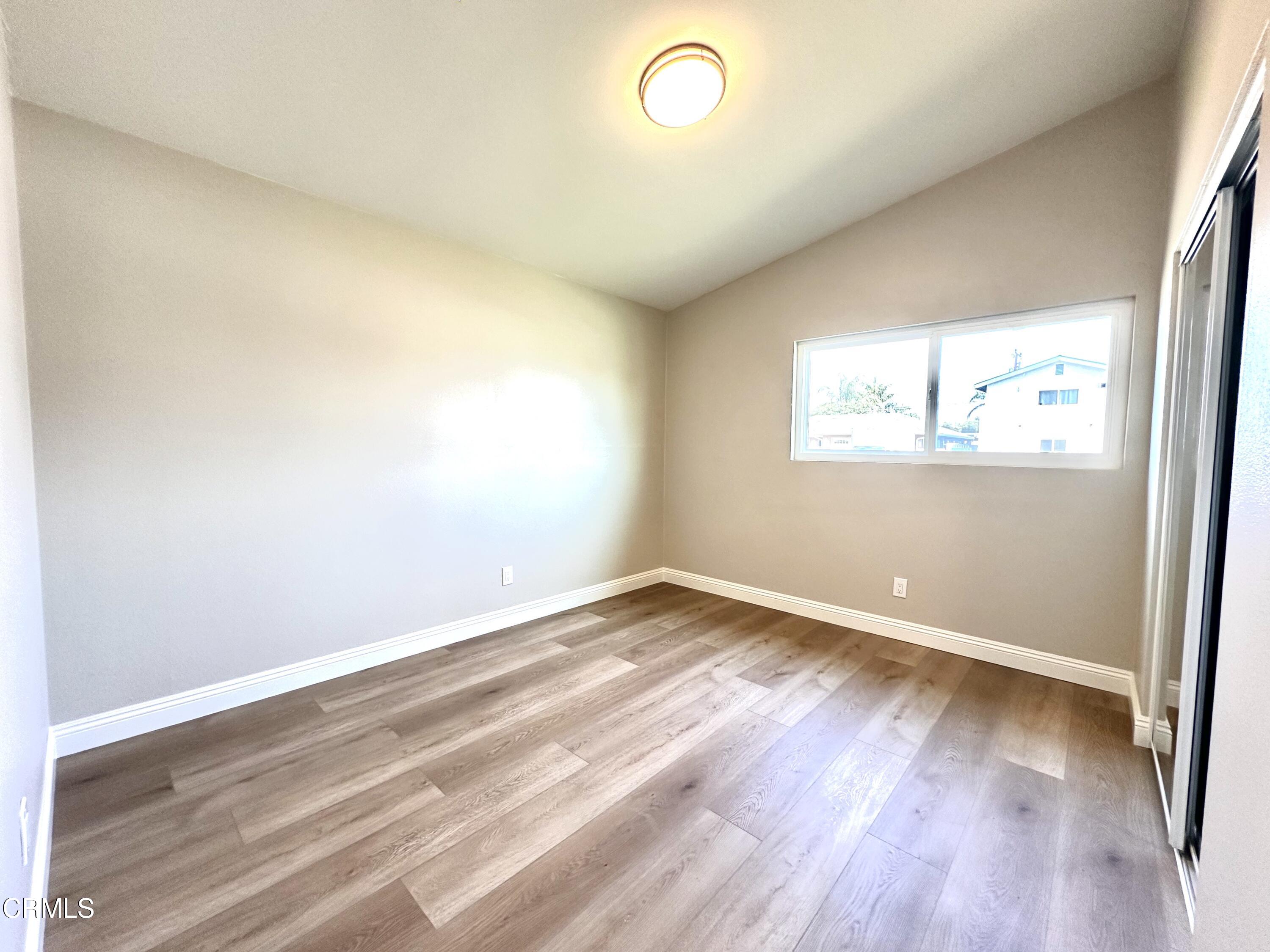 3031 Merced Place Oxnard, CA 93033 - Photo 20 of 26 an empty room with wooden floor and windows