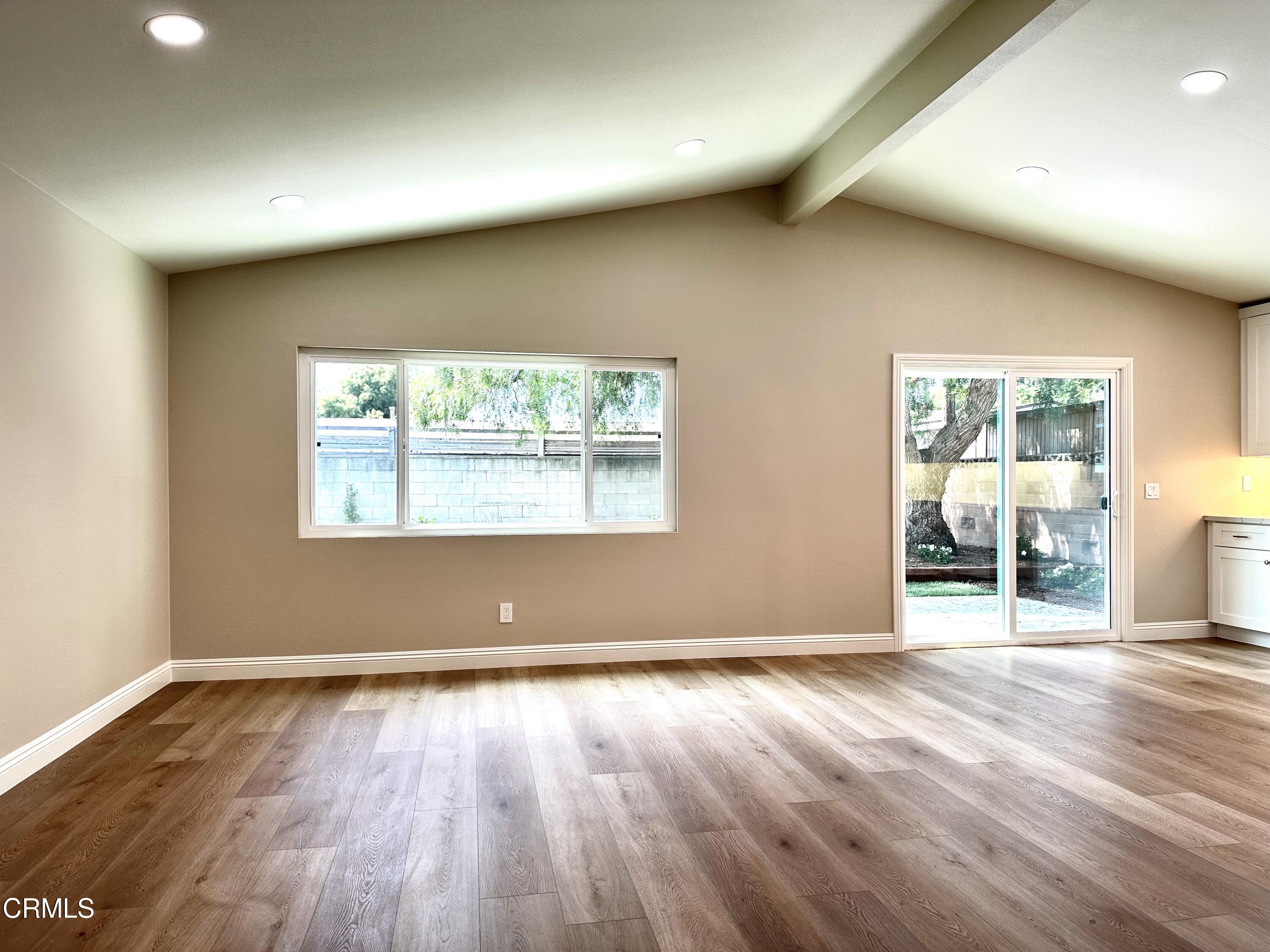 3031 Merced Place Oxnard, CA 93033 - Photo 4 of 26 an empty room with wooden floor and windows