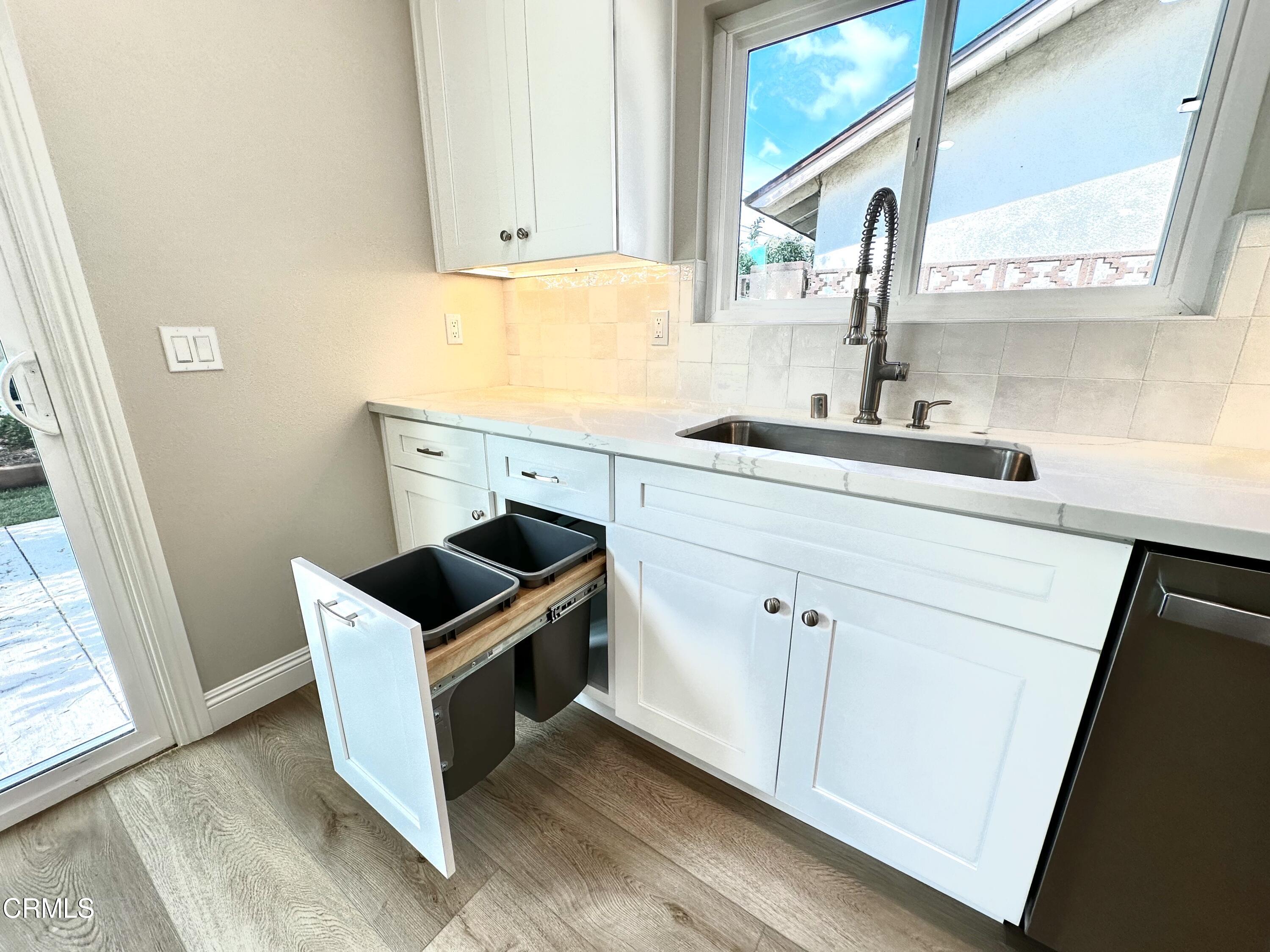 3031 Merced Place Oxnard, CA 93033 - Photo 8 of 26 a kitchen with granite countertop a sink and a stove