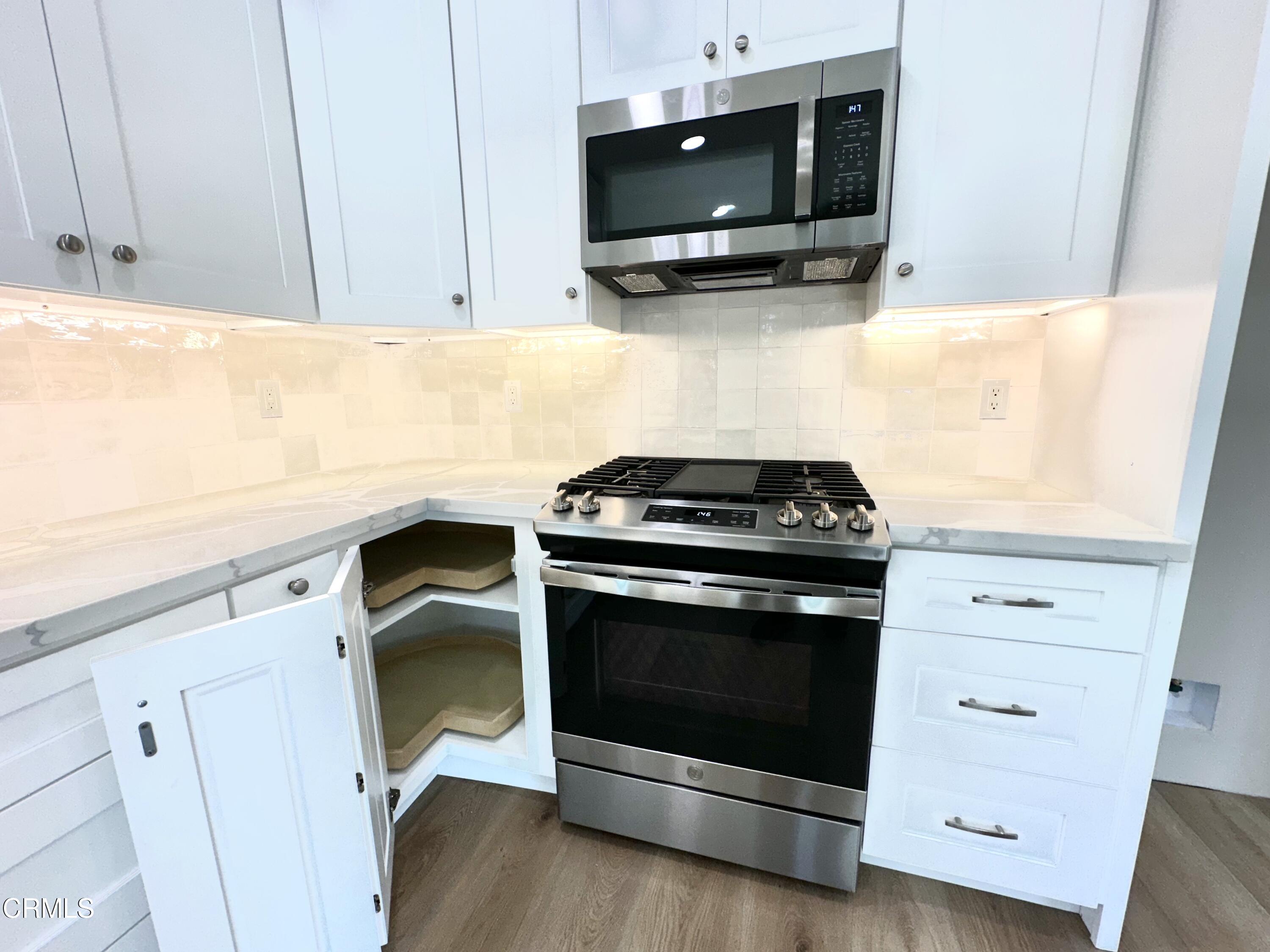 3031 Merced Place Oxnard, CA 93033 - Photo 10 of 26 a kitchen with a stove and a microwave