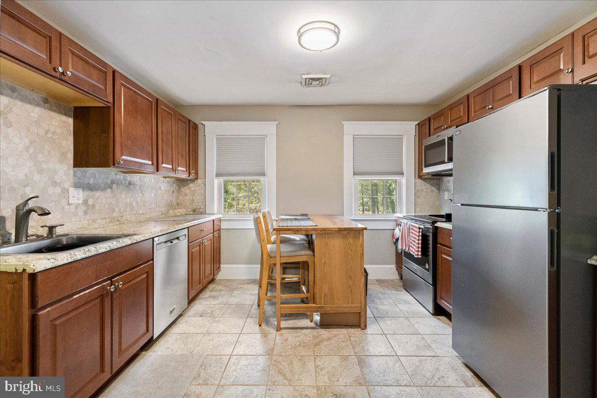 206 Washington Road Princeton, NJ 08540 - Photo 20 of 34 a kitchen with a refrigerator and a sink
