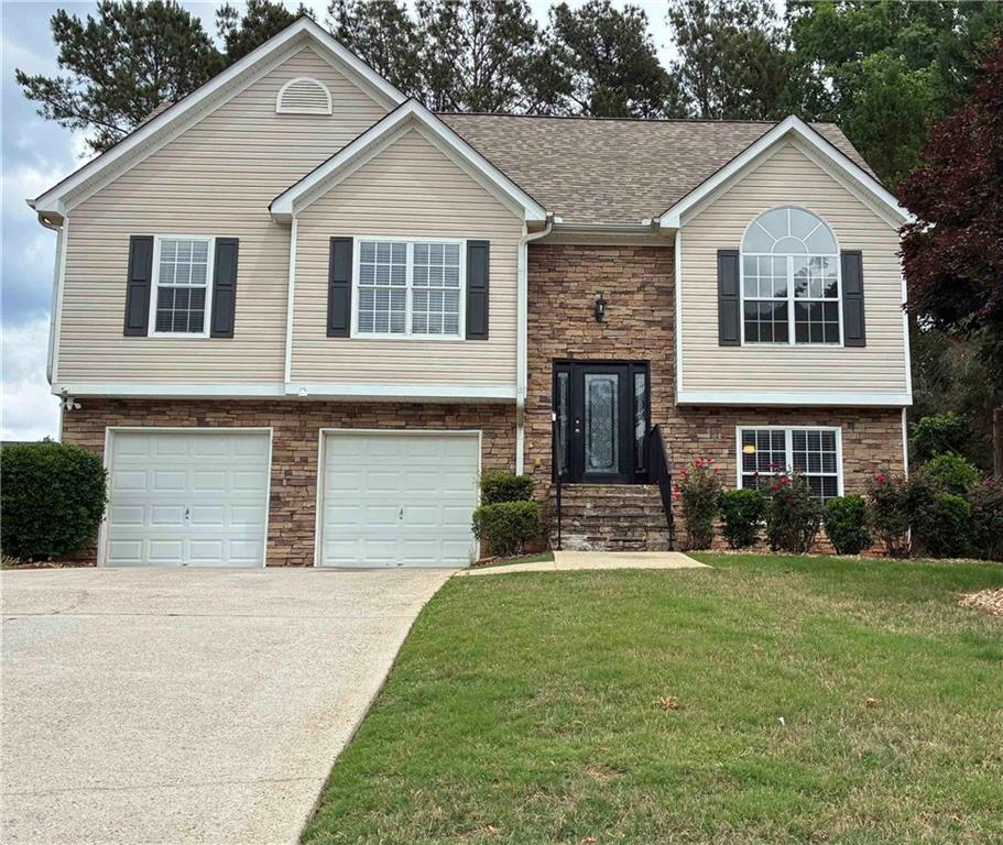 337 Madison Avenue Hampton, GA 30228 - Photo 1 of 32 a front view of a house with a yard and garage