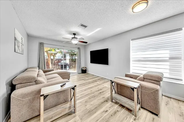 a kitchen with granite countertop a sink cabinets and stainless steel appliances