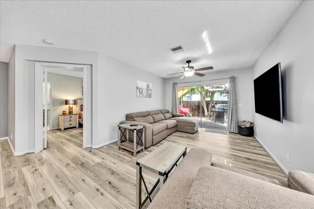 a kitchen with stainless steel appliances granite countertop a refrigerator microwave and sink