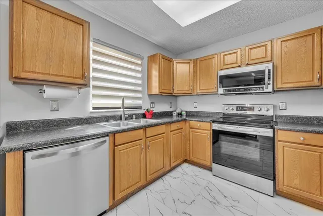 a spacious bedroom with a bed and a flat screen tv