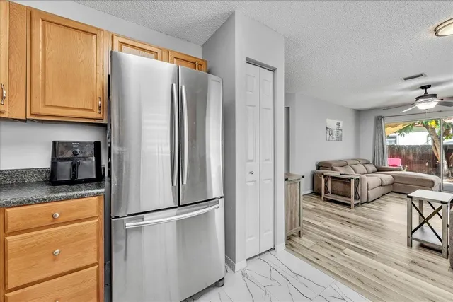 a spacious bathroom with a granite countertop sink toilet and a mirror