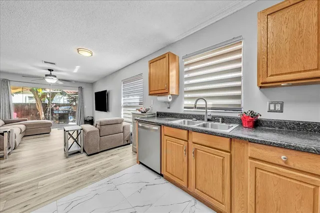 a bathroom with a granite countertop sink a mirror and shower