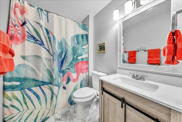 a backyard of a house with barbeque oven table and chairs