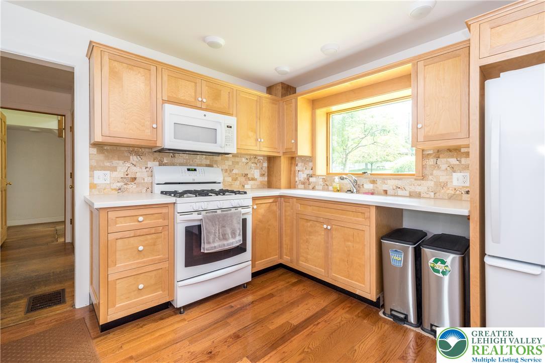 1815 Leithsville Road Hellertown, PA 18055 - Photo 3 of 38 A well-equipped kitchen boasts warm wood cabinetry, gleaming countertops, and durable hardwood flooring.