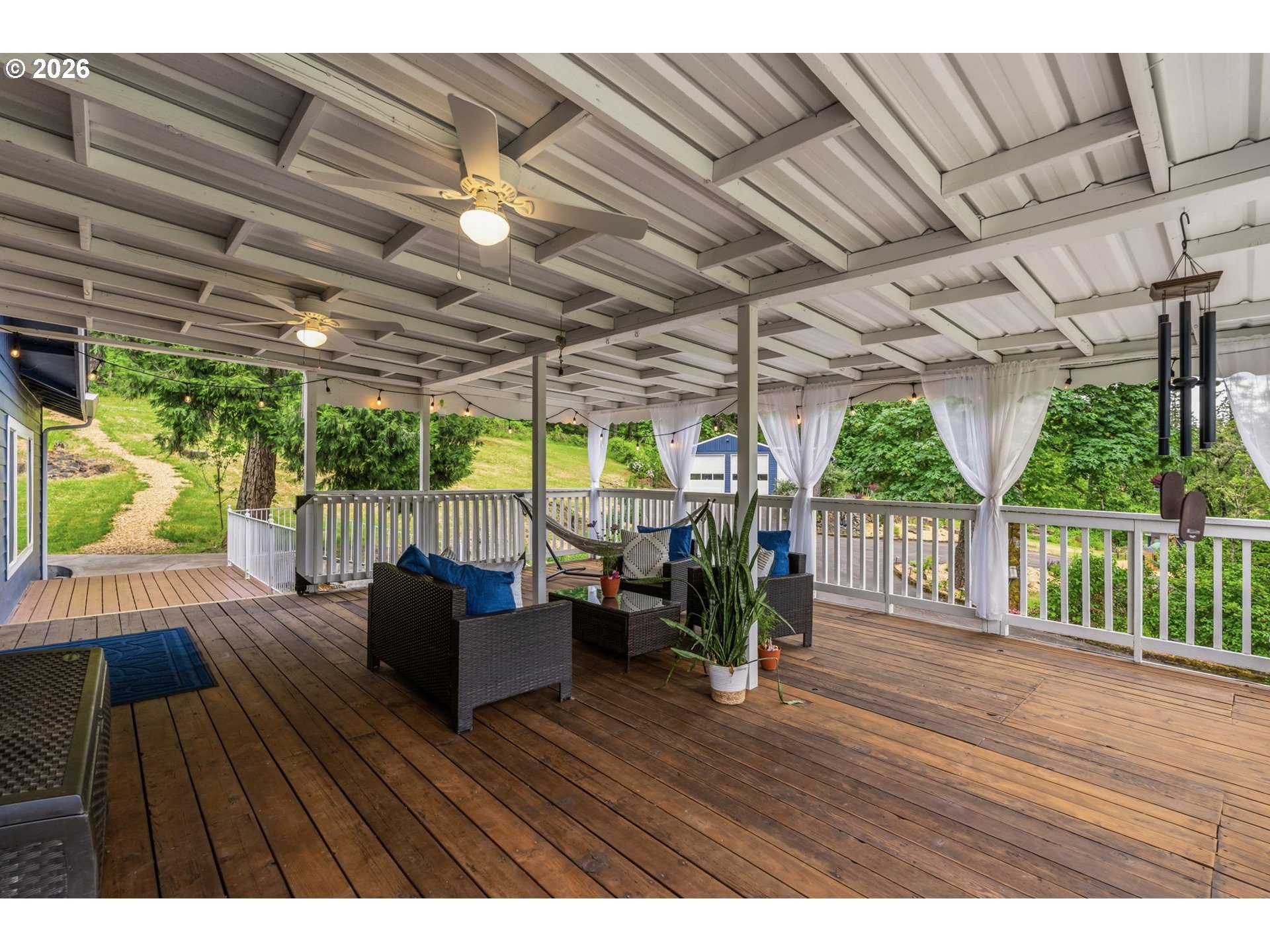 89093 Marcola Road Springfield, OR 97478 - Photo 11 of 25 a view of a patio with table and chairs potted plants with wooden floor