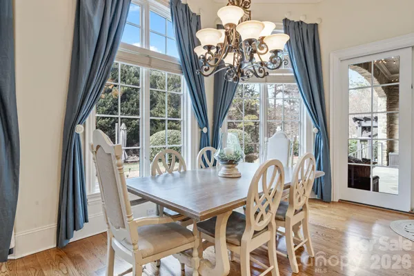 a view of a dining room with furniture and a floor to ceiling window