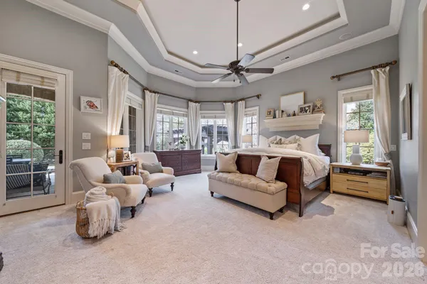 a bedroom with furniture and large windows