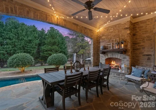 a view of a patio with a dining table and chairs