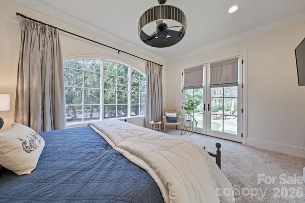 a spacious bedroom with a large bed and a large window