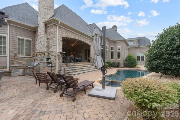 a view of a house with backyard and sitting area