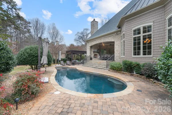 a view of a house with swimming pool and sitting area