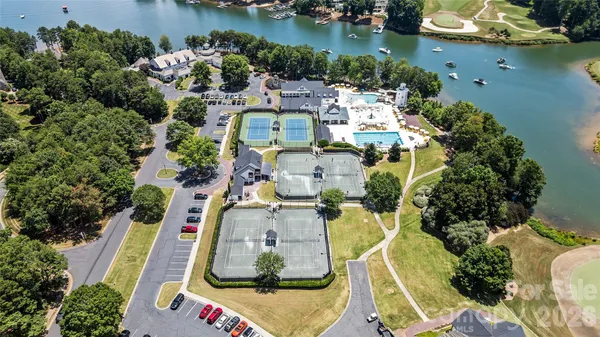 an aerial view of residential houses with outdoor space and lake view