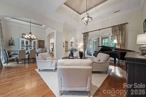 a living room with furniture and a chandelier
