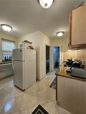 a kitchen with refrigerator and mirror