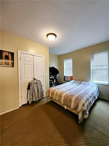 a bedroom with bed and a closet