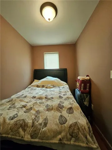 a bedroom with a bed and window