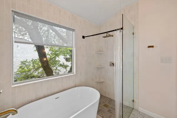 a bedroom with a bed and window